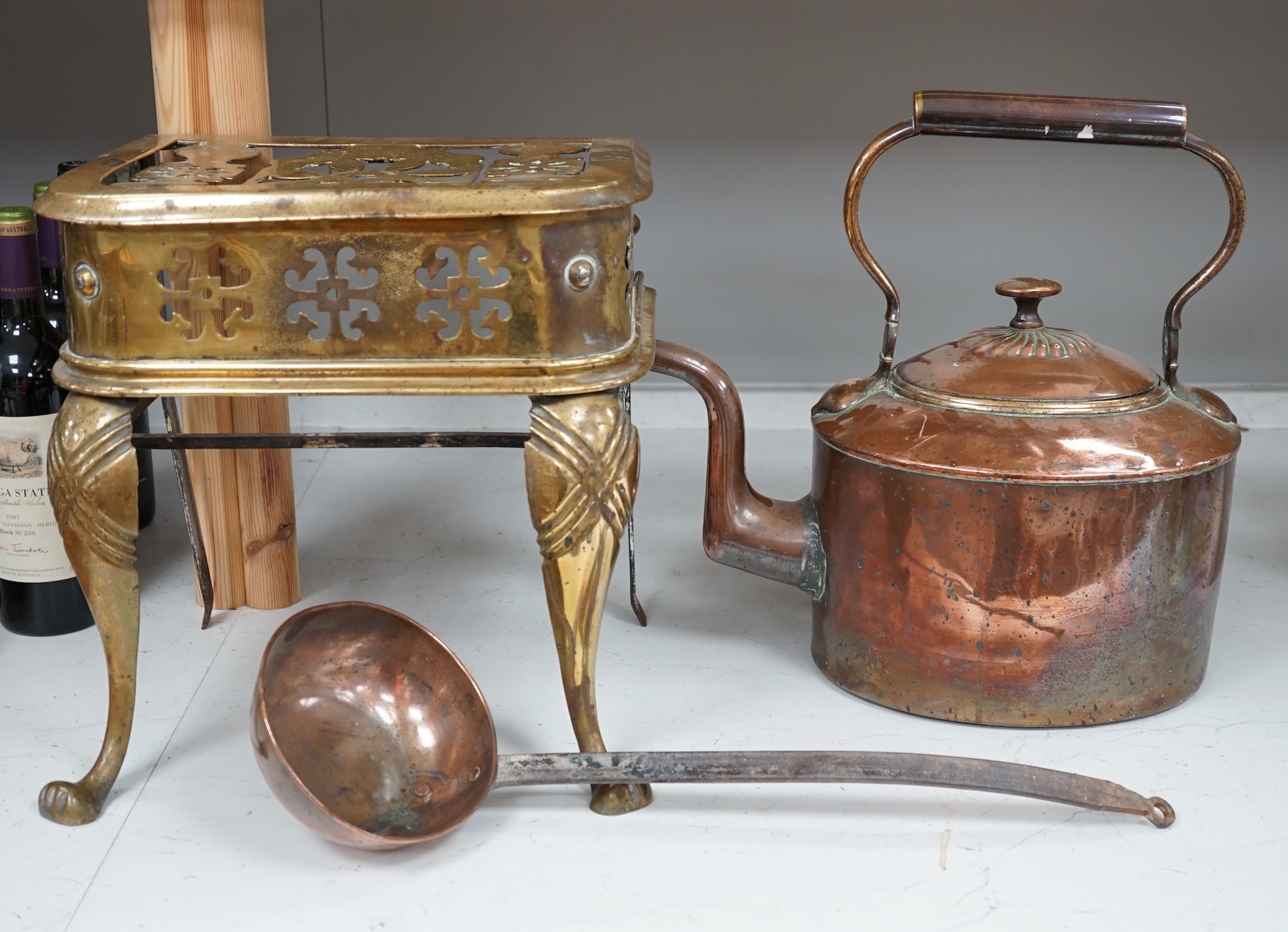 A late Victorian copper kettle, a brass stand and a ladle, largest 39cm wide. Condition - fair